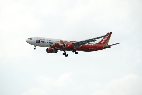 Free A VietJet Air Airbus A330 airplane captured flying in clear skies. Stock Photo