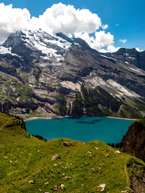 Free Breathtaking view of Lake Oeschinen surrounded by the majestic Swiss Alps in summer. Stock Photo