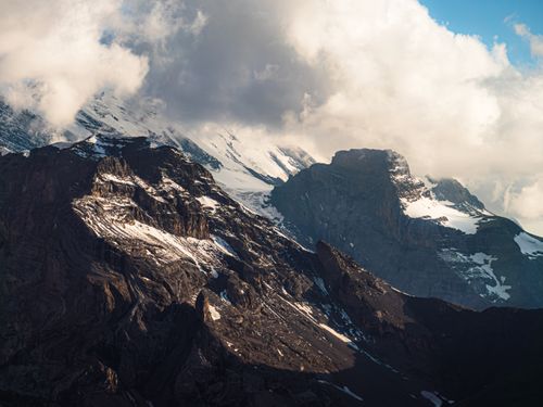 Free Breathtaking view of the Swiss Alps in Kandersteg with dramatic clouds and snow-capped peaks. Stock Photo