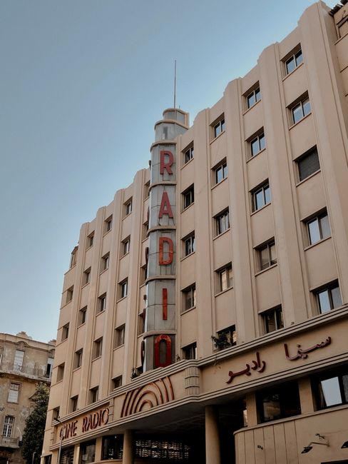 Art Deco building featuring a vertical RADIO sign in a cityscape setting.