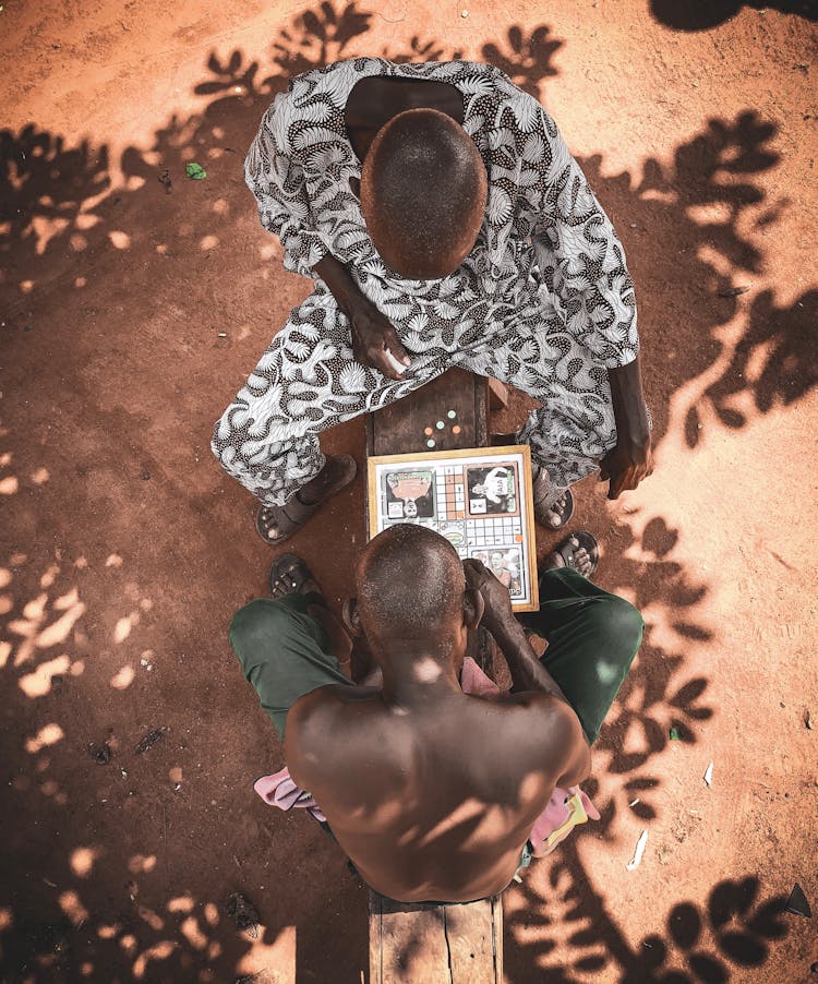 Top View Photo Of Men Playing Board Game