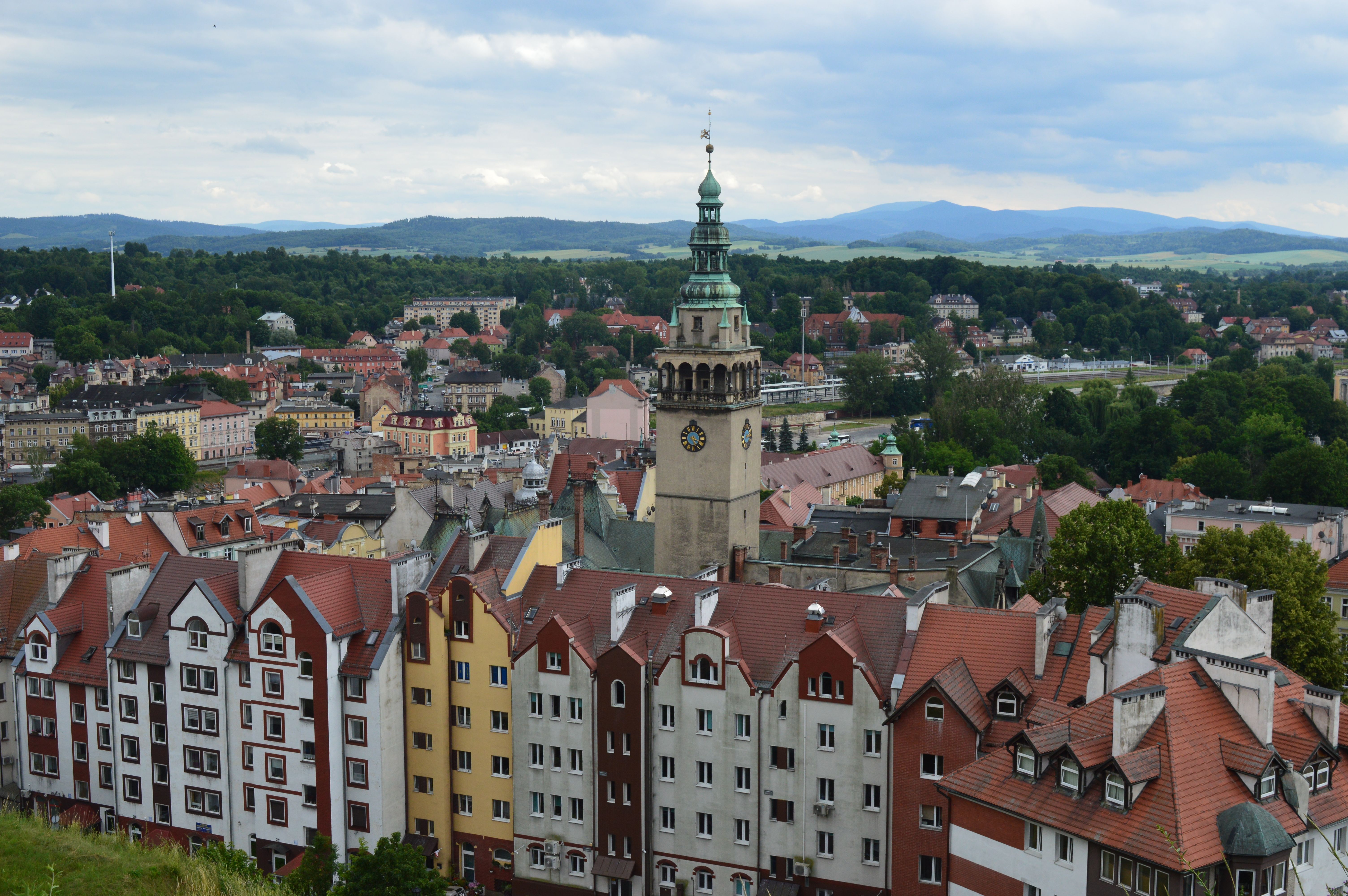 Discover the charming architecture and scenic landscape of Kłodzko, Poland from above.