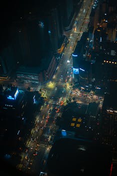 A vibrant aerial view of a busy Seoul intersection at night, capturing city lights and traffic.