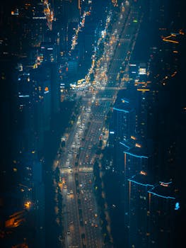 Aerial shot of Seoul's bustling night traffic with illuminated skyscrapers.