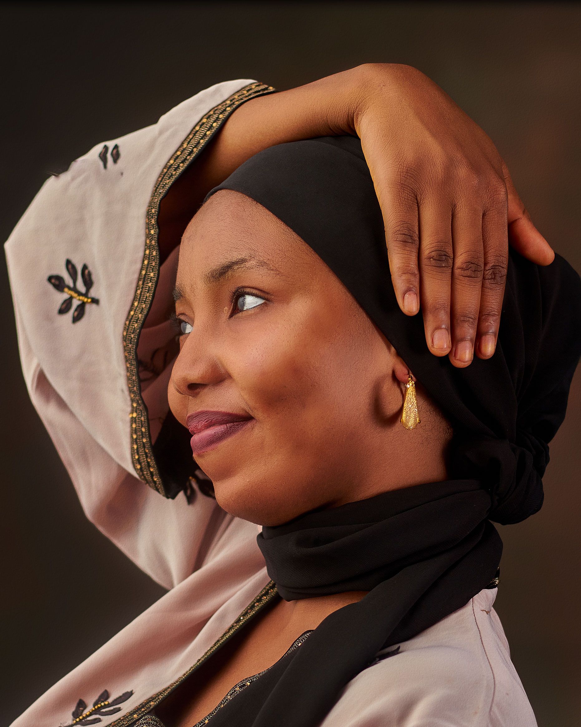 Close-up portrait of a woman in traditional attire, smiling warmly.