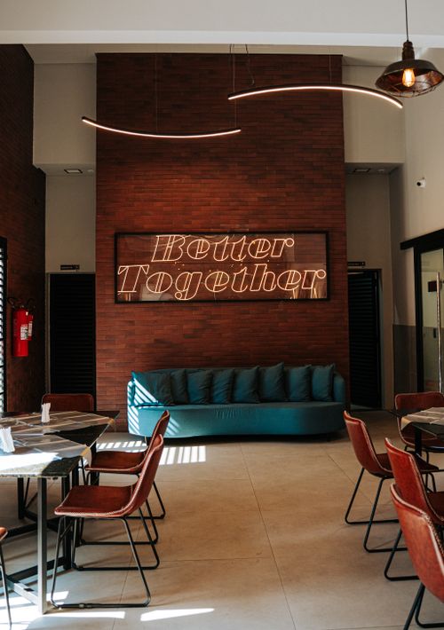 Free Chic industrial-style cafe with 'Better Together' neon sign in Guarulhos, São Paulo. Stock Photo