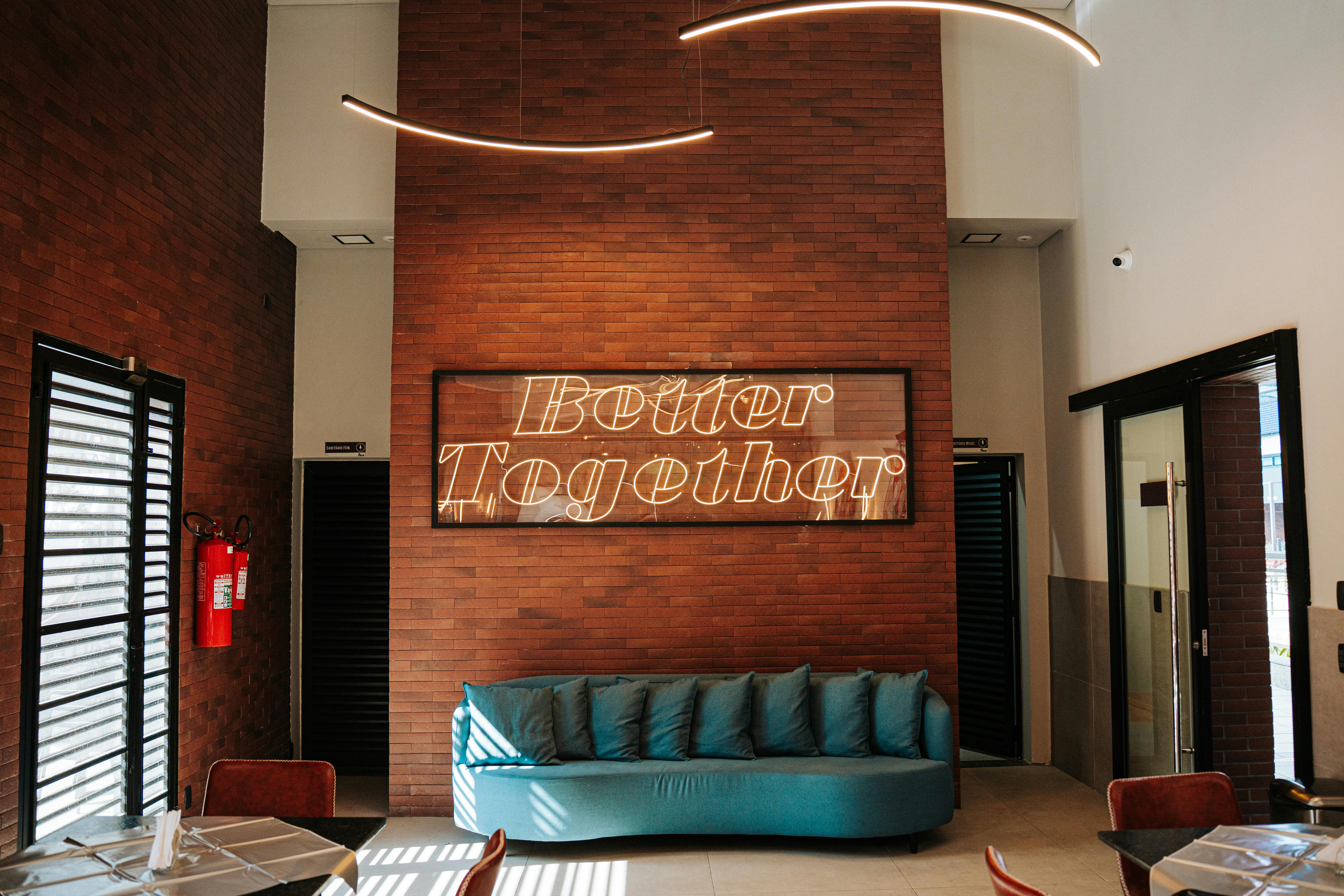 Stylish lounge interior with brick walls, neon sign, and modern furniture in Guarulhos, São Paulo, Brasil.
