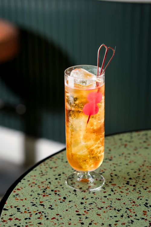 Free A refreshing cocktail with ice and stirrer on a stylish terrazzo table in a New York bar. Stock Photo
