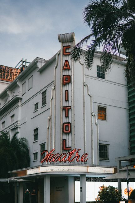 Captivating view of the iconic Capitol Theatre in Singapore, showcasing its vintage architecture and neon signs.