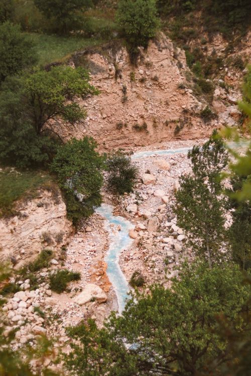 Free Beautiful aerial view of a blue river winding through a lush, rocky canyon Stock Photo