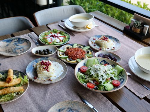Free A beautifully set table with a variety of Mediterranean dishes including salads and appetizers. Stock Photo