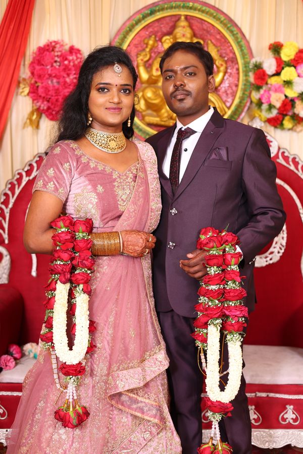 Indian wedding couple wearing floral garlands during rituals