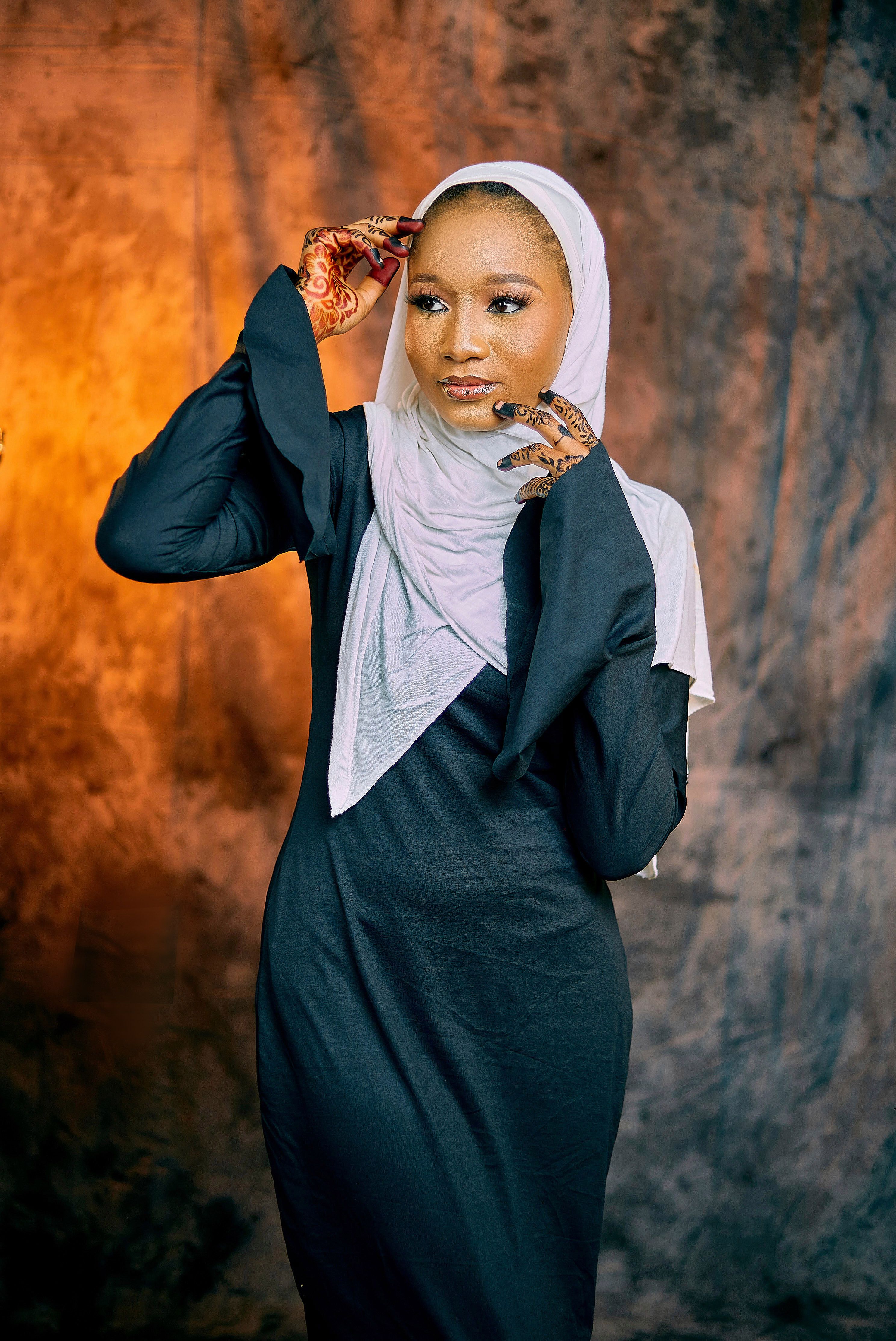 Elegant Woman in Black Dress with Henna and Hijab · Free Stock Photo