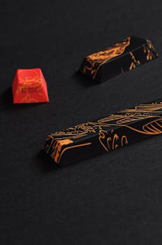 Close-up of vibrant colored designer keycaps with intricate patterns on a black surface.