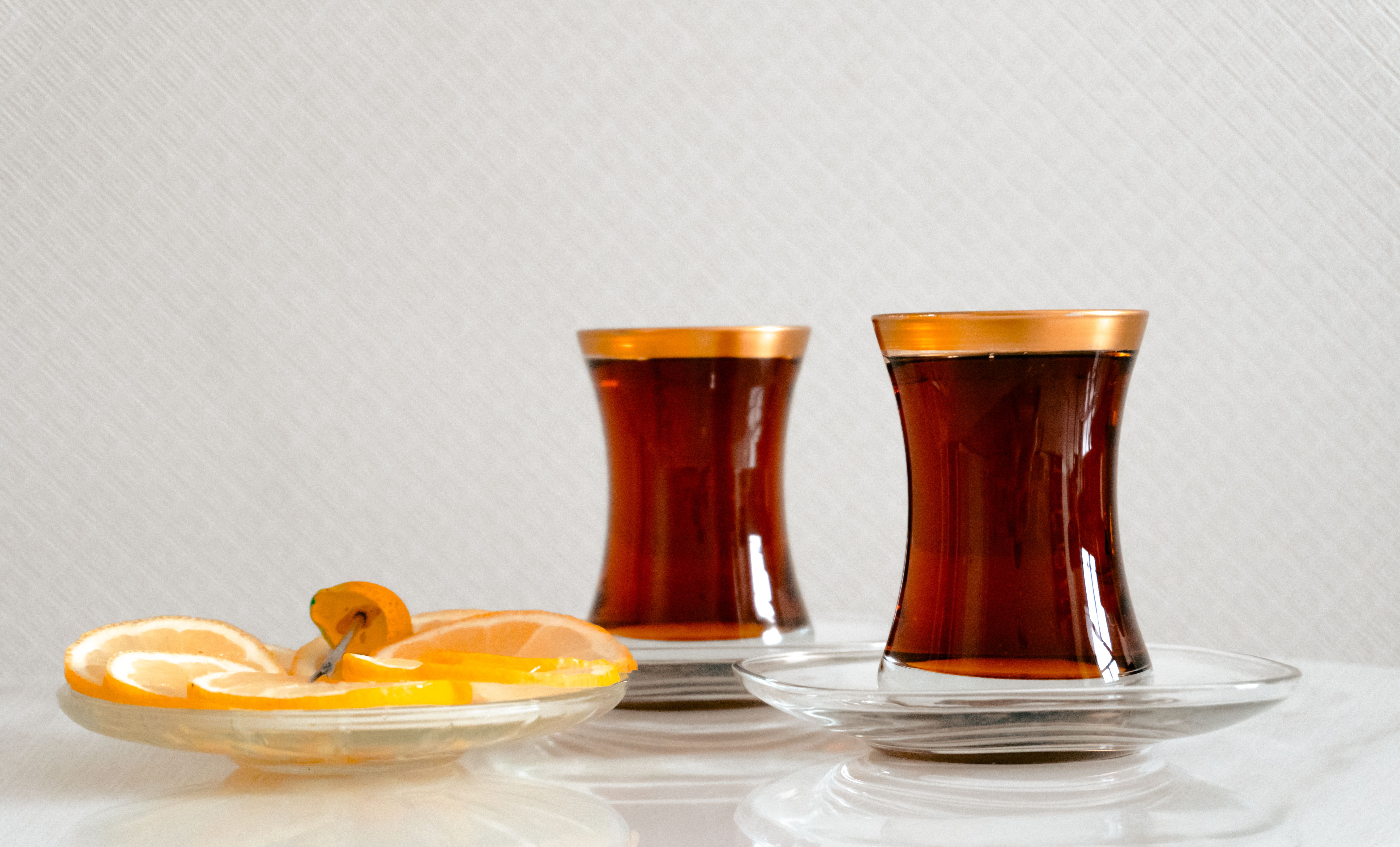 A traditional Azerbaijani tea set with Armudu glasses, jams, and sweets