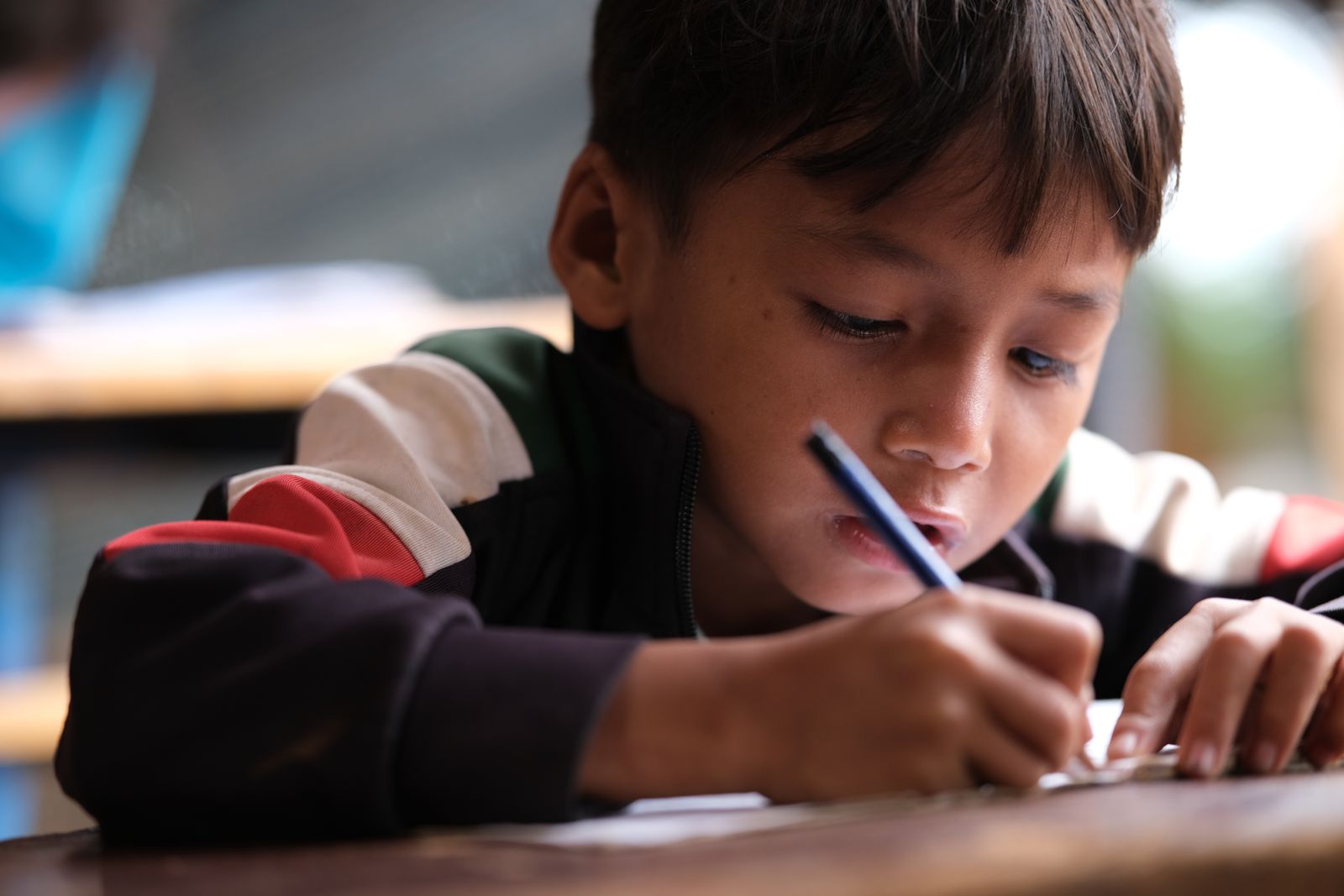 A child engaged in writing.