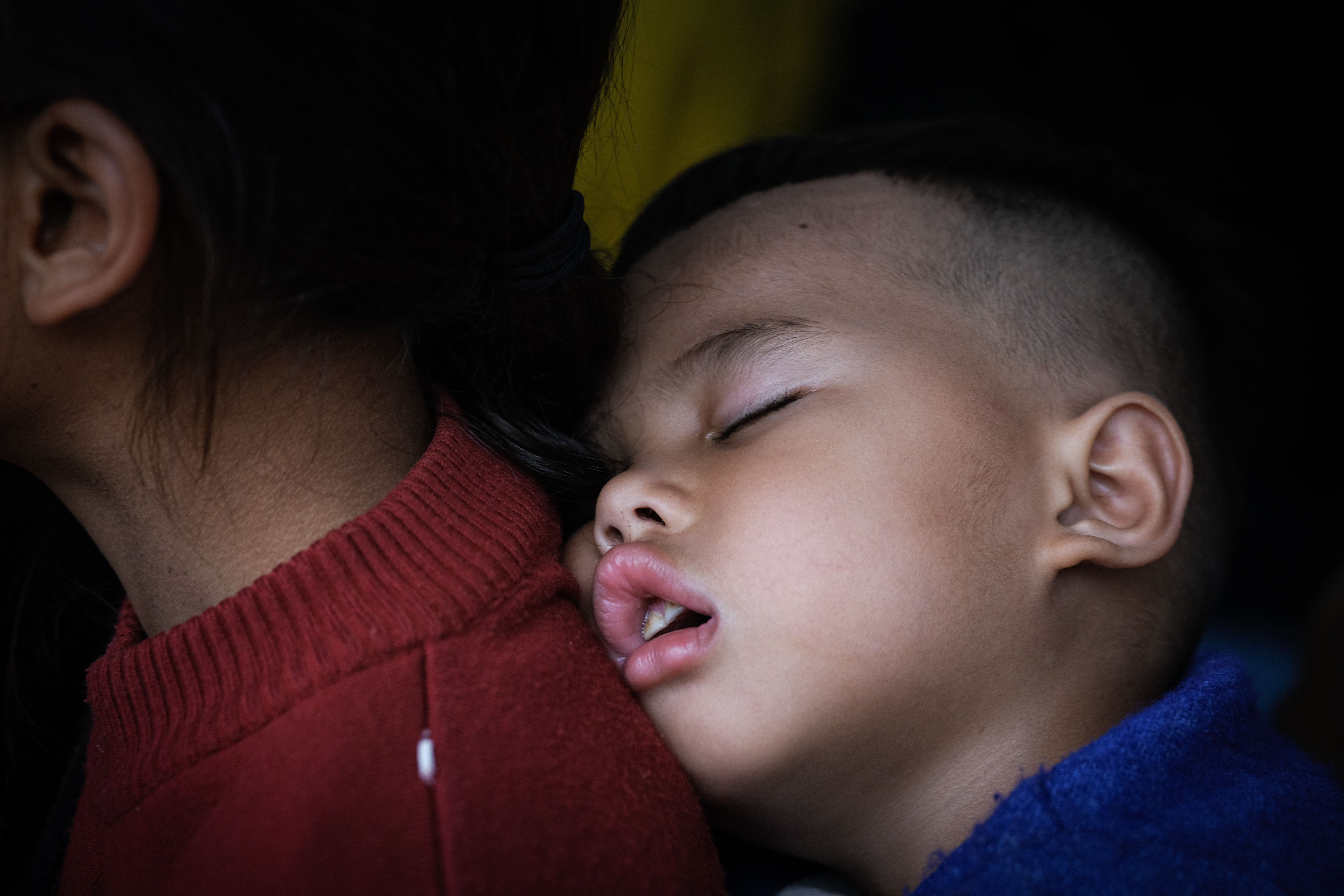 Sleeping Child Resting on Mother's Back · Free Stock Photo