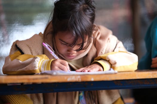Young girl attentively writing in a classroom environment, showcasing focus and learning.