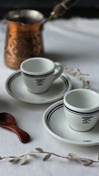High-quality image of espresso cups with a copper pot, perfect for coffee-themed content.