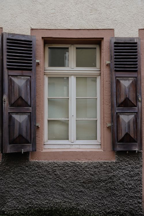 Free Quaint window with rustic wooden shutters in traditional Heidelberg architecture. Stock Photo