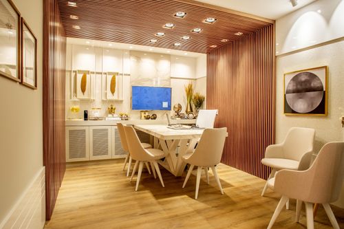 Free Modern dining room with elegant decor, featuring a stylish table and chairs set, cozy lighting, and artwork. Stock Photo