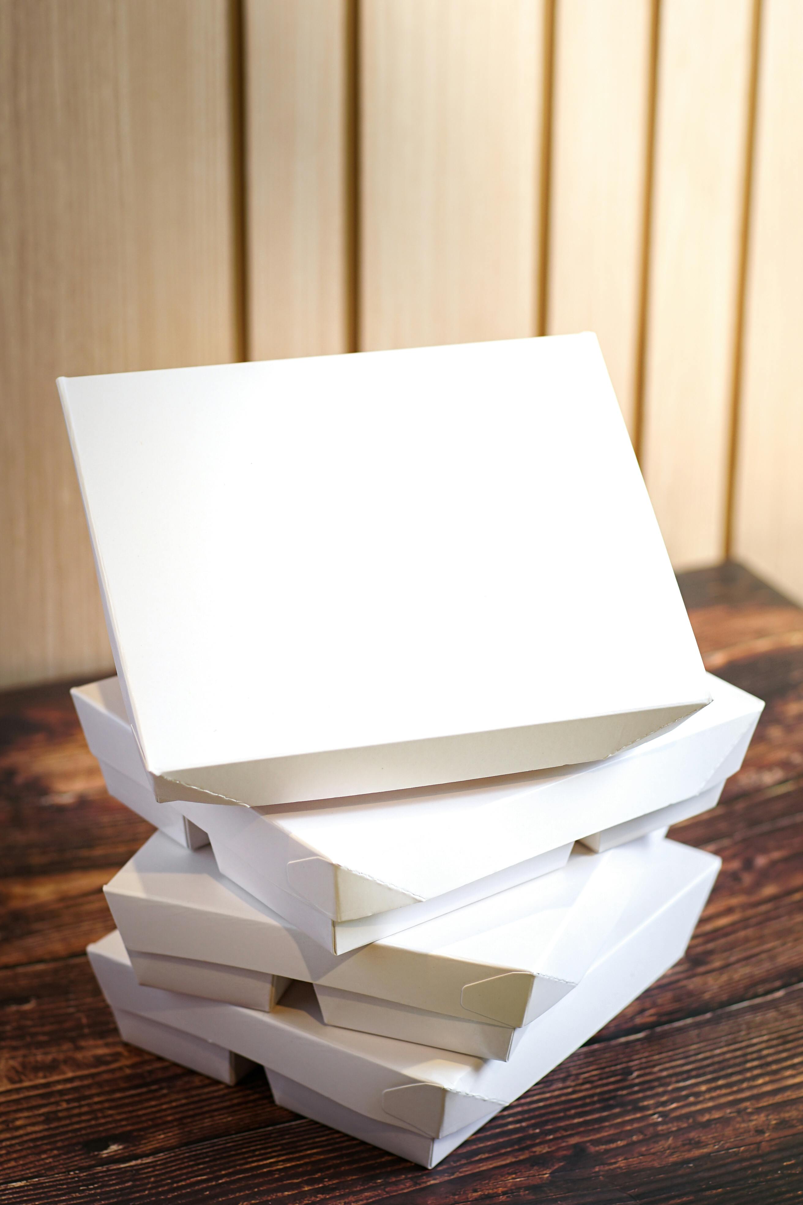 Minimalist photo of stacked white boxes perfect for package design and branding.