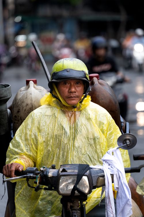 Vietnamese Motorcycle Rider Vietnamese Motorbike Rider in Rainy Saigon · Free Stock Photo