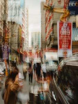 Blurred vibrant street scene in Manila's Chinatown during day with lanterns and bustling crowd.