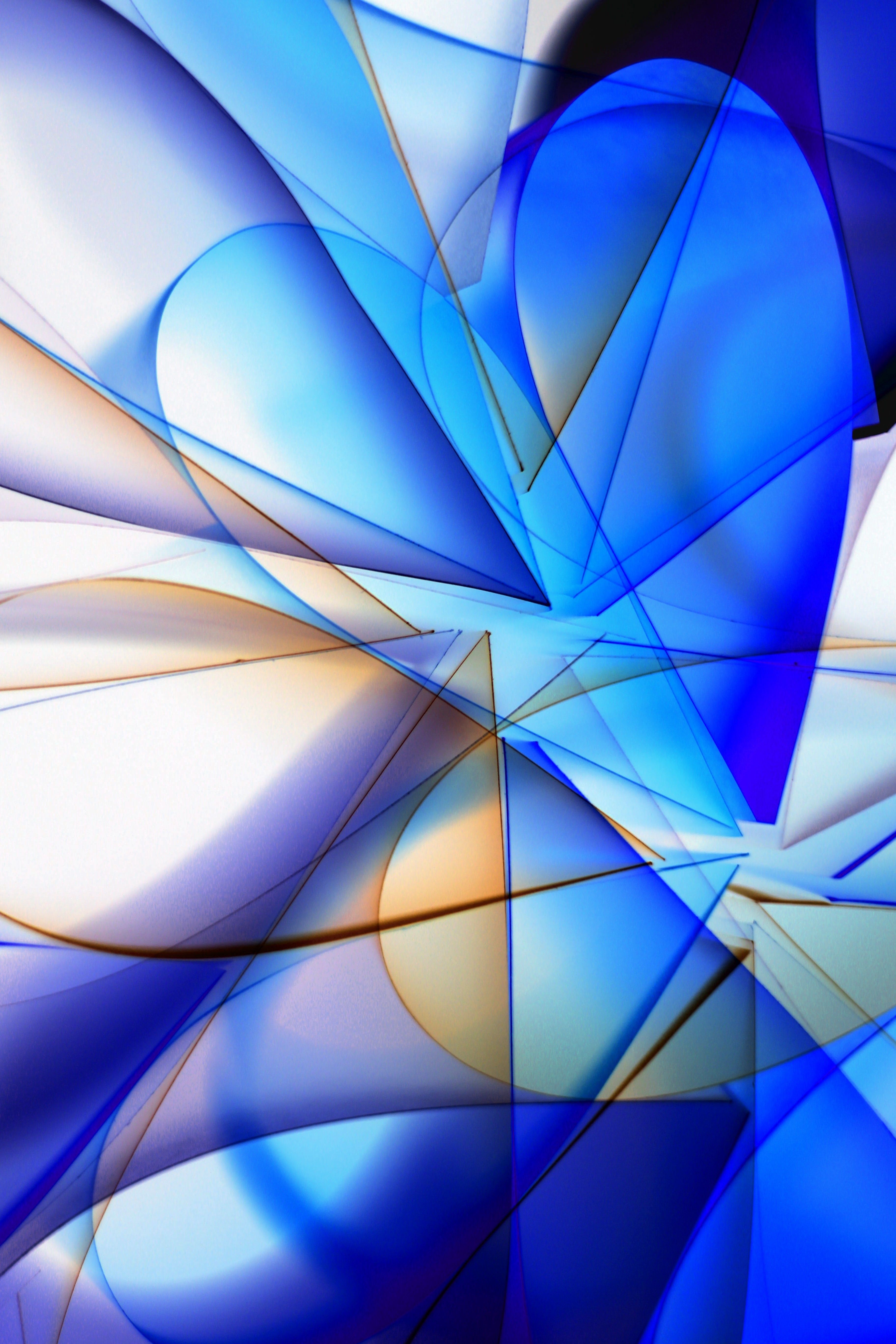 Dynamic abstract composition featuring blue and orange geometric shapes intersecting vividly.