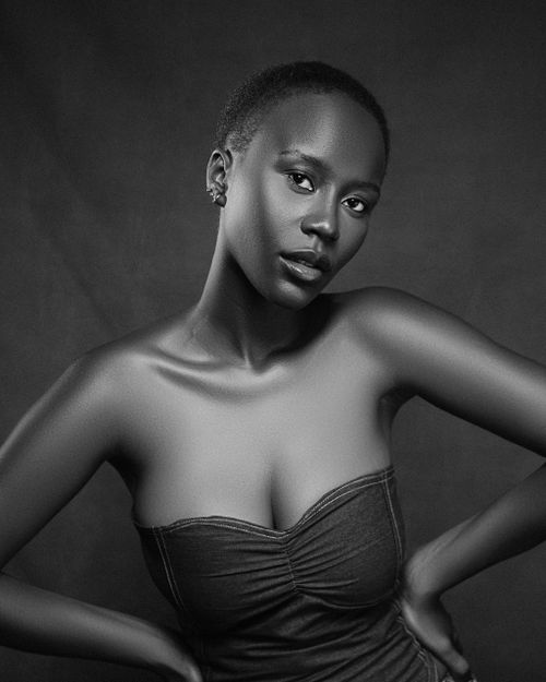 Free Stunning black and white portrait featuring a confident woman with a short hairstyle. Stock Photo