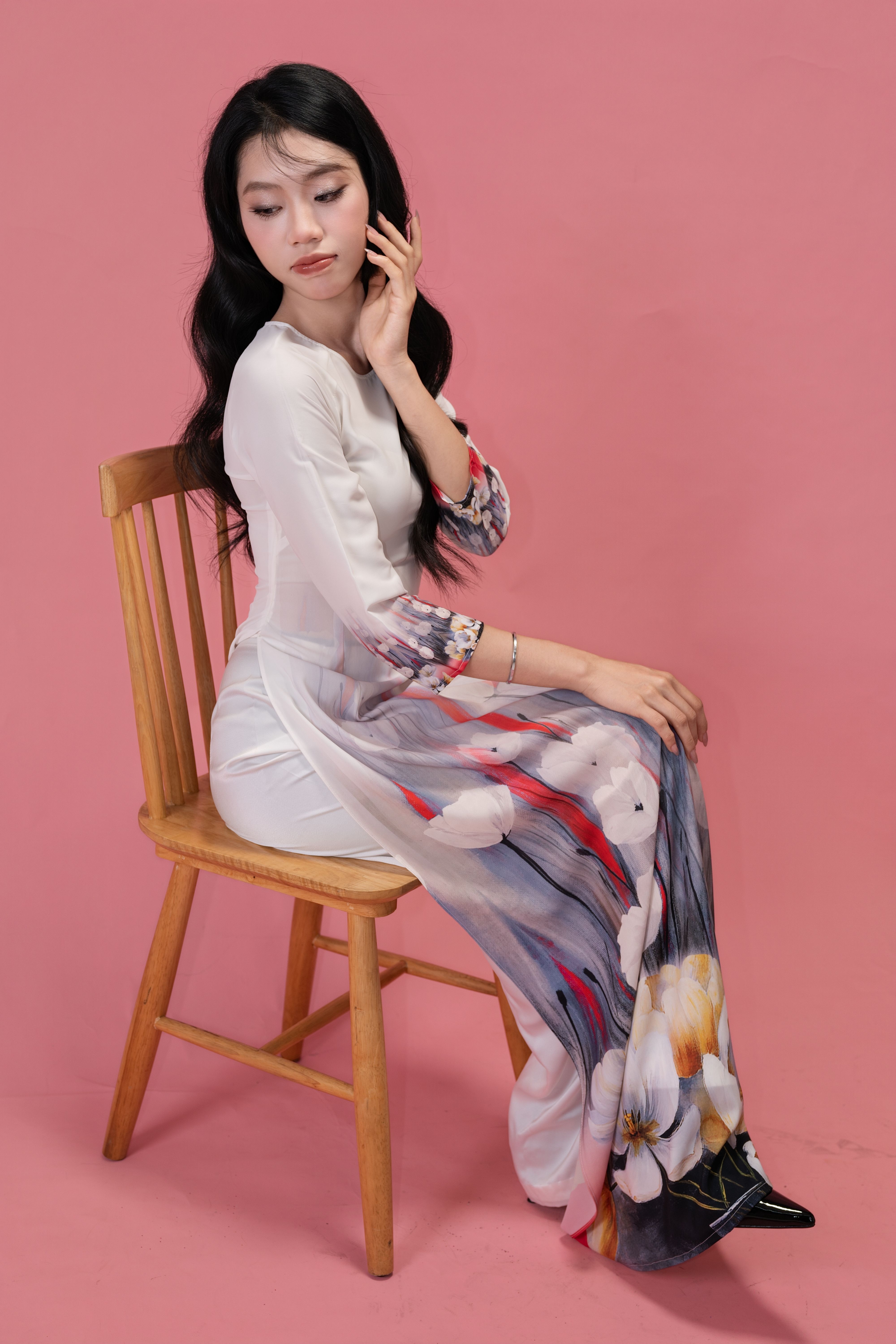 Elegant Woman in Floral Dress Seated on Chair · Free Stock Photo