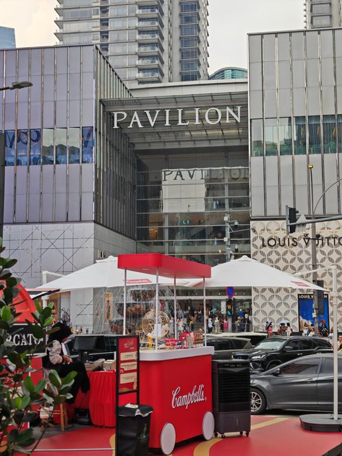Free Bustling urban scene at Pavilion Mall with a food cart and high-end stores. Stock Photo