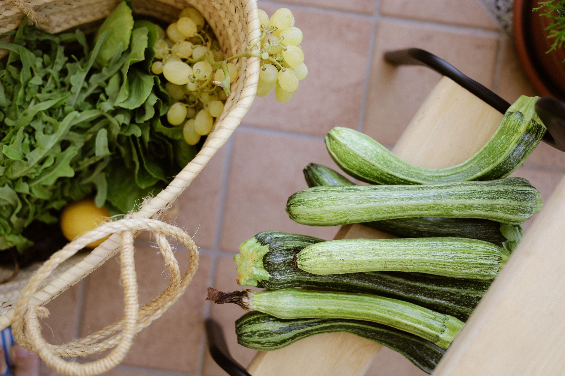 Delicious Zucchini Recipes for Your Summer Harvest Top view of fresh zucchini and greens in basket, ideal for organic lifestyle stock photos.