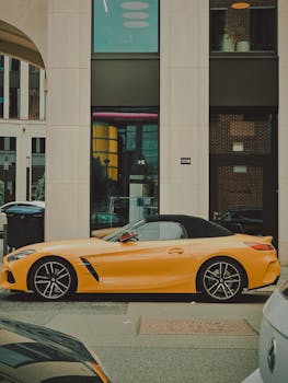A sleek vibrant yellow BMW sports car parked in a Berlin city street.