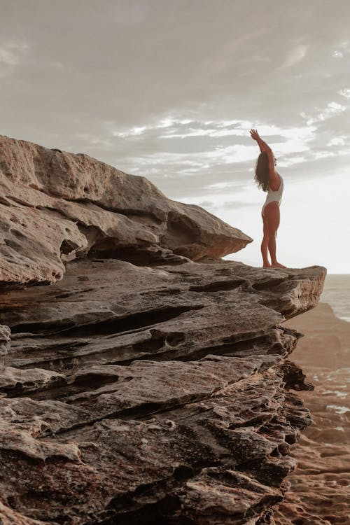 Free Woman on Rock in White Bathing Suit Stock Photo