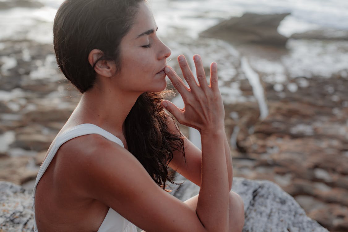 Woman Wearing White Tank Top Meditating