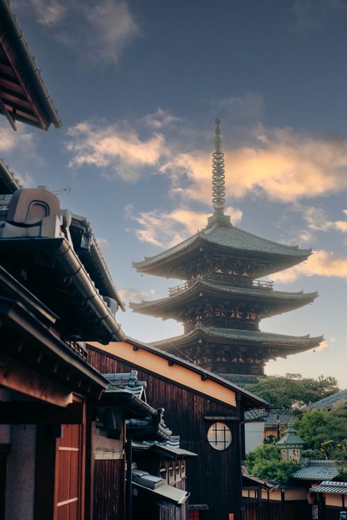 Free Scenic view of a traditional pagoda at sunset, surrounded by historic architecture in Kyoto. Stock Photo