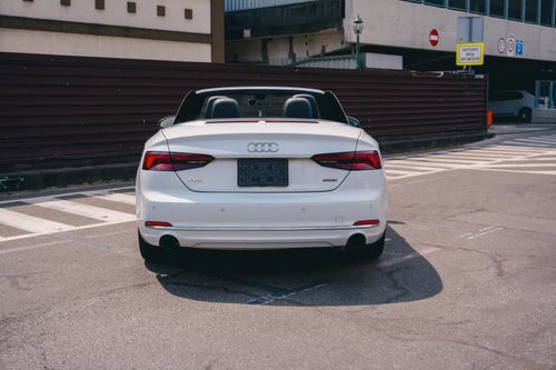 Free White convertible car parked in a sunny urban setting in Kyiv, Ukraine. Stock Photo