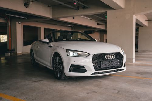 Free Luxury white convertible parked in a modern urban garage in Kyiv, Ukraine. Stock Photo