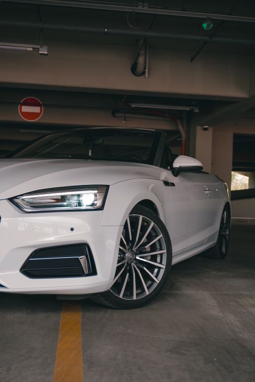Free White luxury convertible parked in indoor garage, sleek design with modern features in Kyiv, Ukraine. Stock Photo