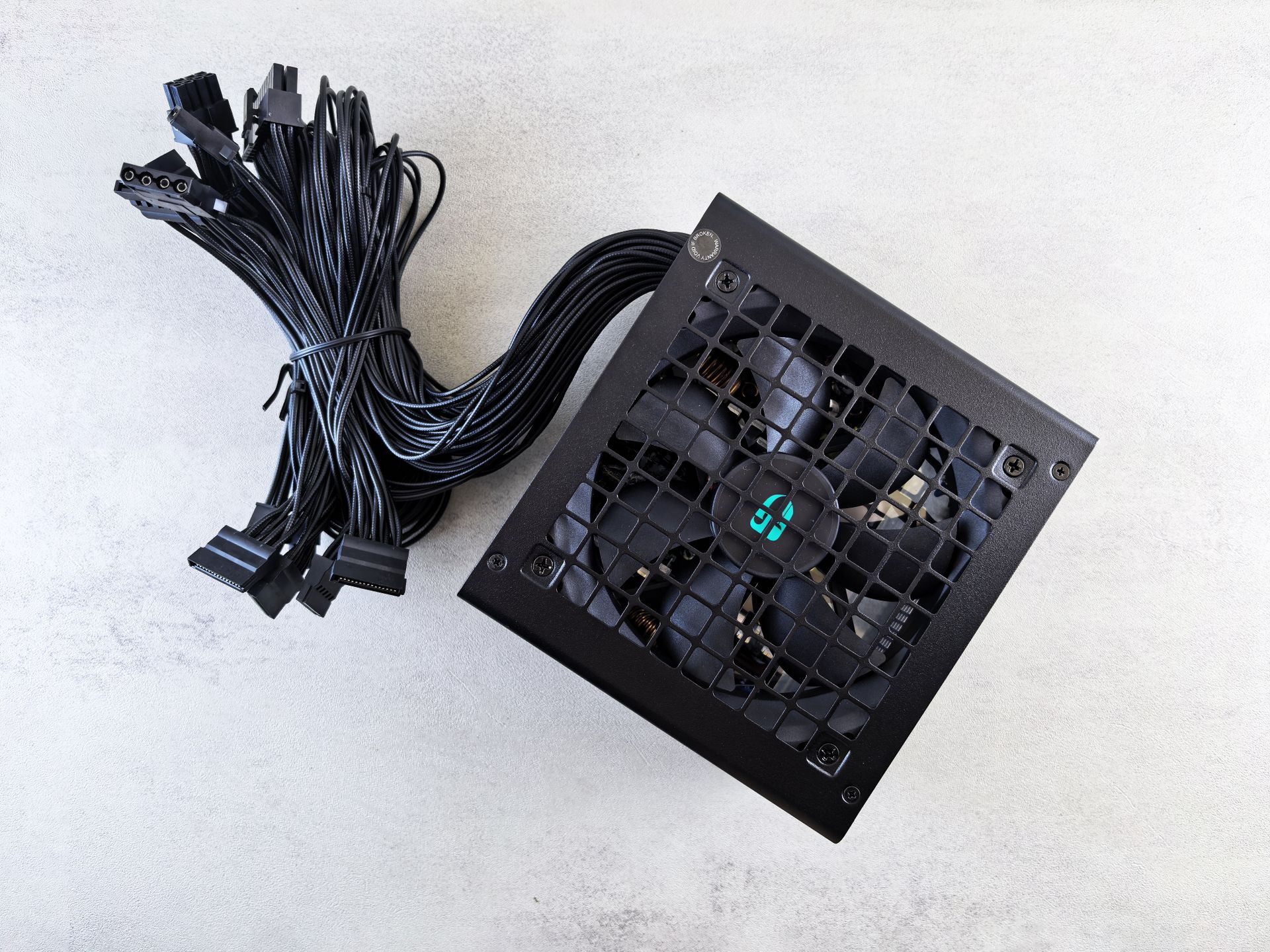 High-quality black power supply unit with multiple connector cables on a white background.
