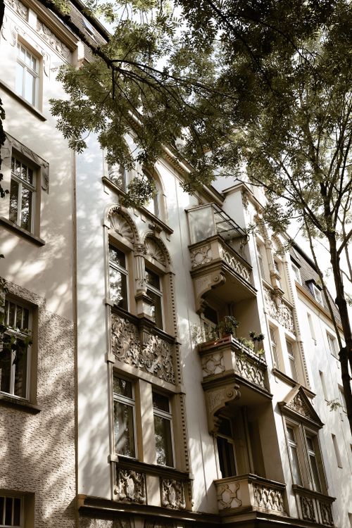 Free Elegant architecture of a historic apartment building in Kassel, Germany, framed by trees. Stock Photo