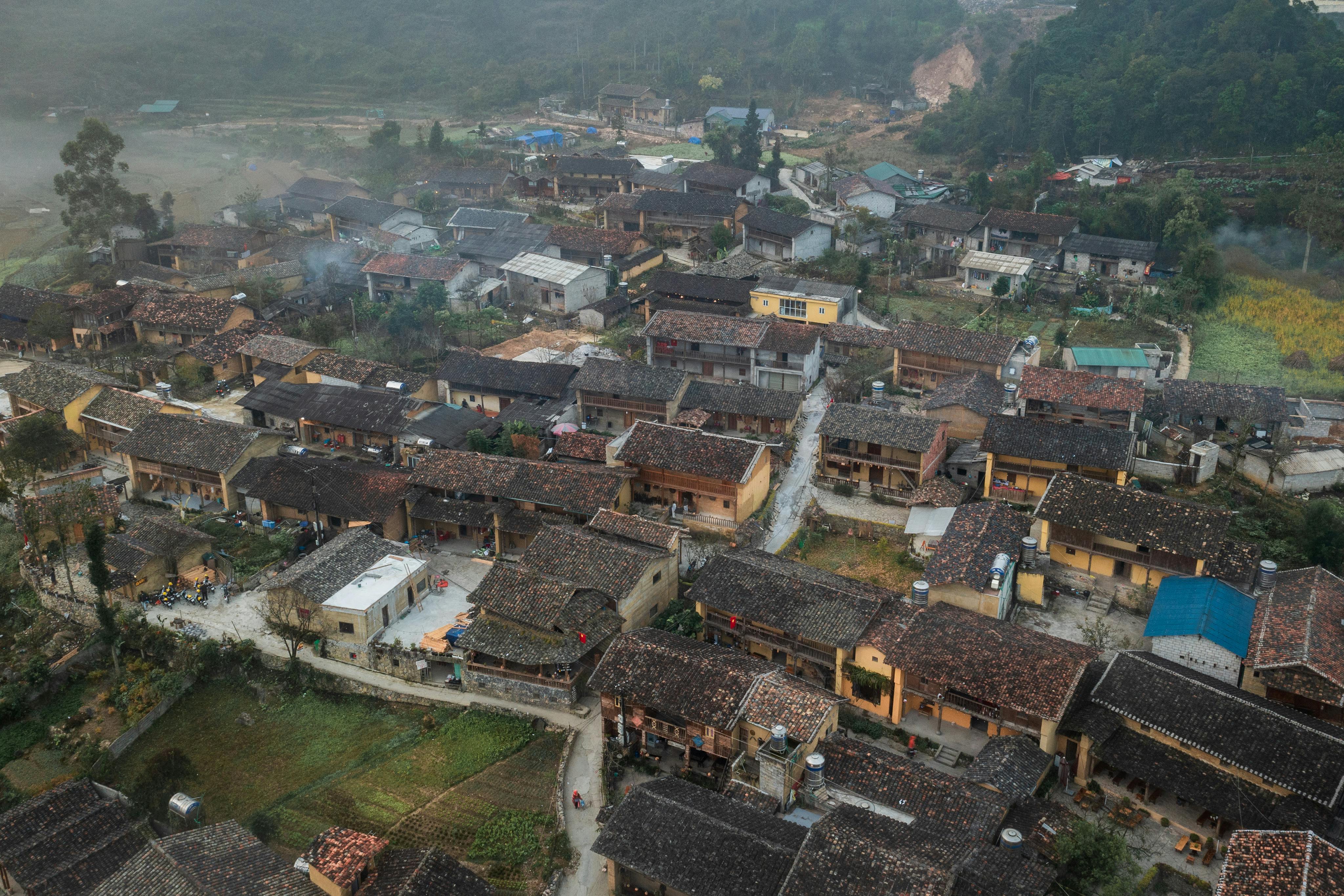 Aerial view showcasing a traditional rural village with classic architecture.