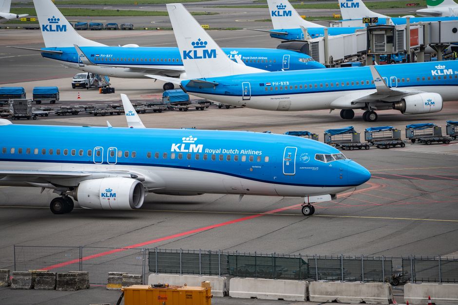 Multiple KLM airplanes parked at Schiphol Airport, ready for departure.