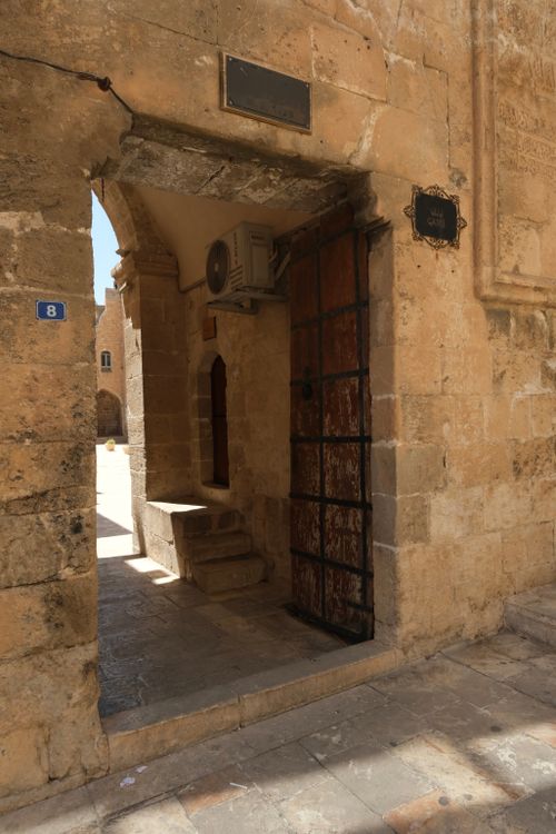 Free Historic stone archway with weathered iron door and ancient architecture. Stock Photo