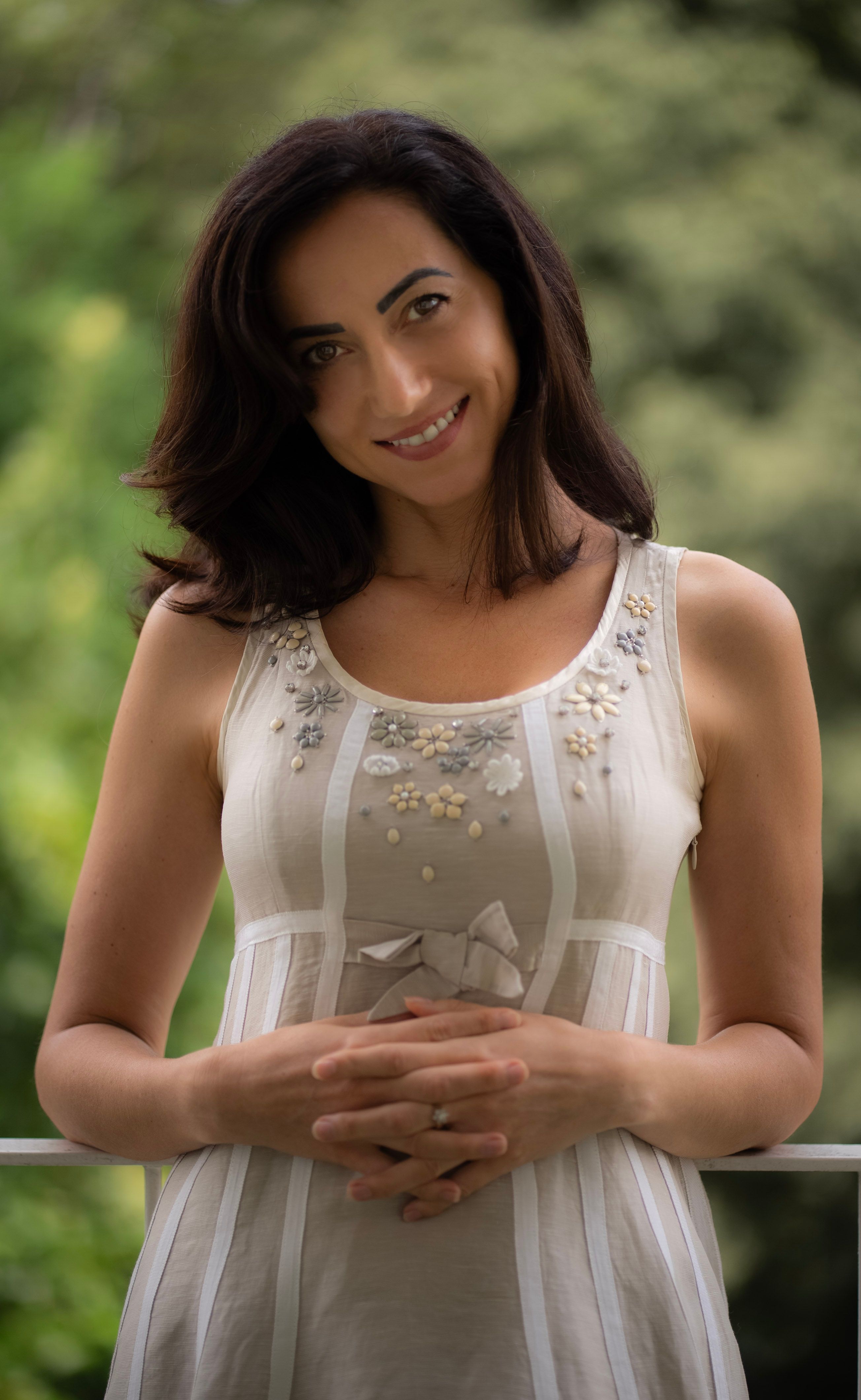 Portrait of a smiling woman outdoors in Milan. Elegant and casual fashion.