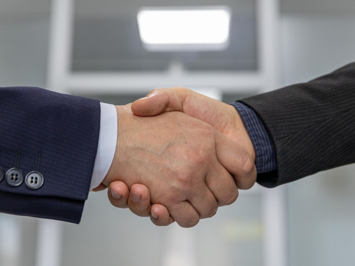 Business partnership handshake