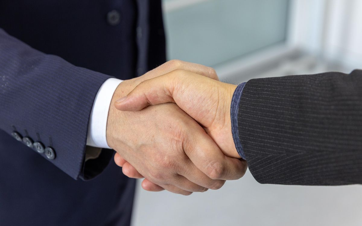 Business partners shaking hands, symbolizing trust and partnership