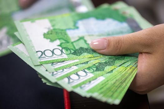 Close-up of a hand holding 2000 Russian Ruble banknotes, financial concept.