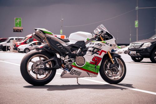 Free A sleek Ducati racing bike parked outdoors at the Nürburgring, with overcast sky. Stock Photo